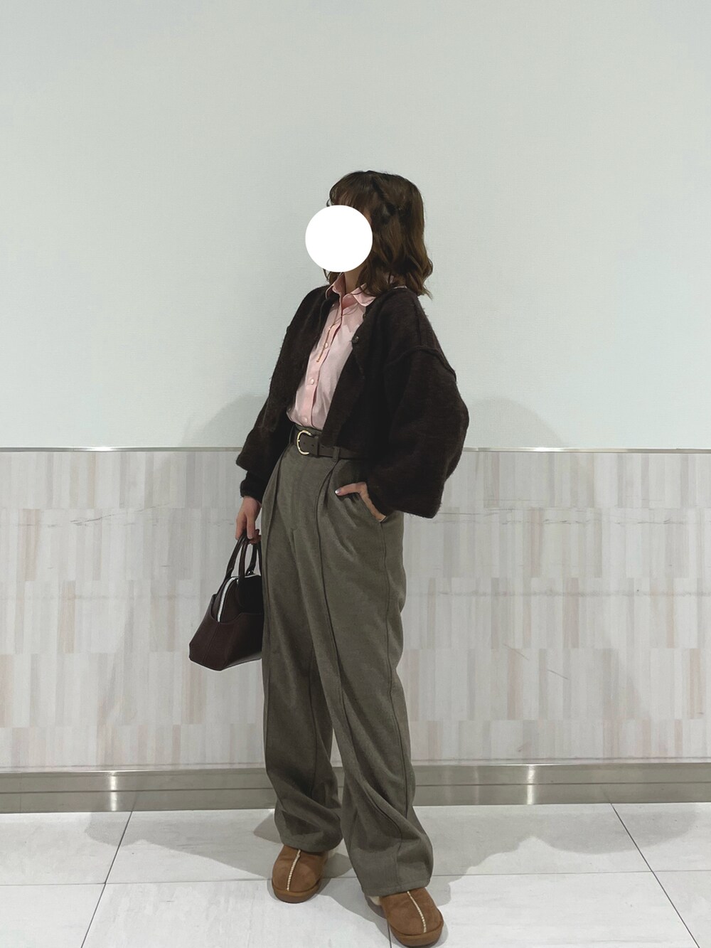 ベージュ系のパンツ、ピンク系のシャツ/ブラウス、ブラウン系のカーディガン/ボレロを着用したレディースの冬コーディネートの2枚目の写真