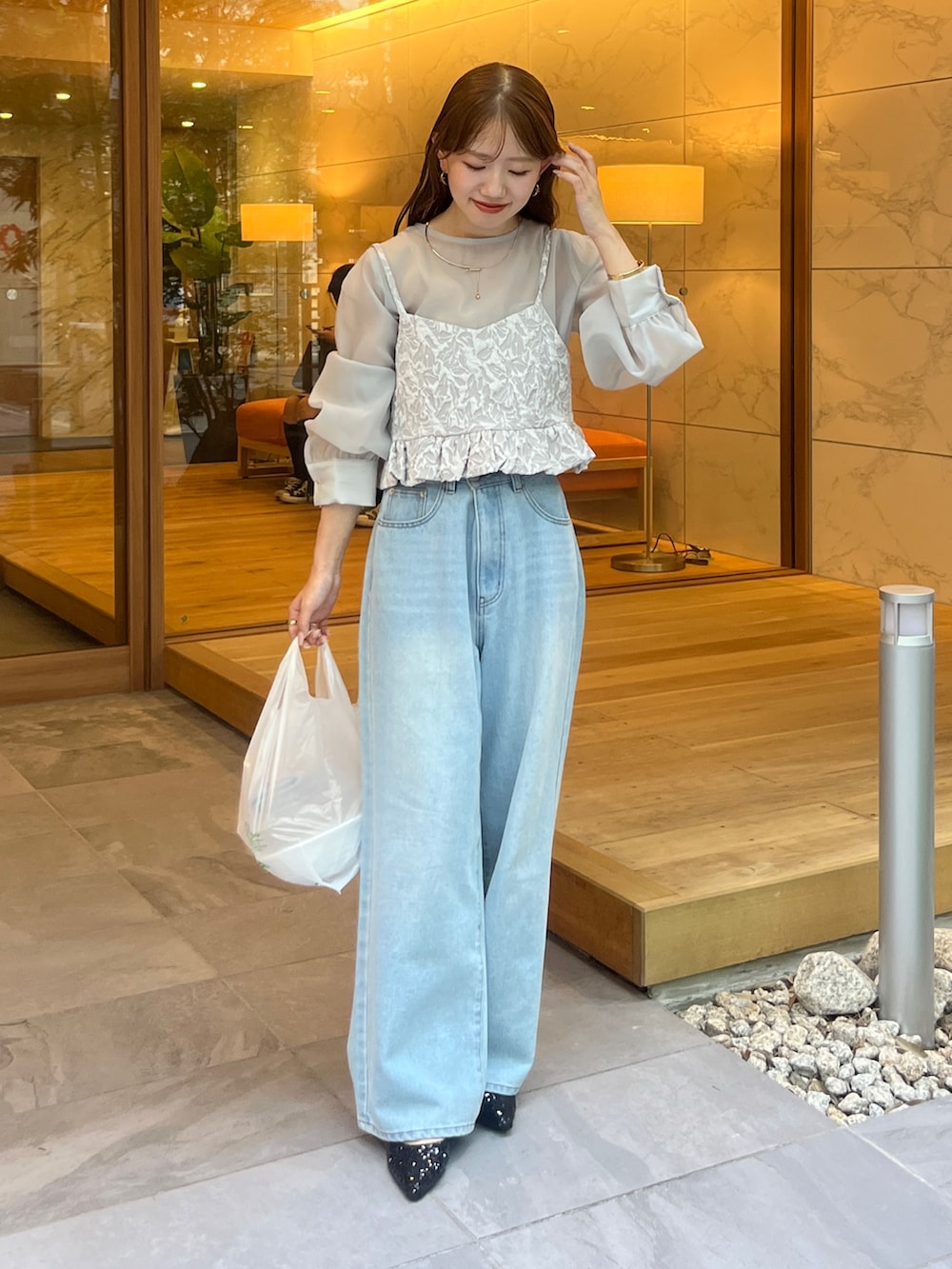 グレー系のシャツ/ブラウス、ブラック系のデニムパンツ、ブラック系のパンプスを着用したレディースの夏コーディネートの2枚目の写真