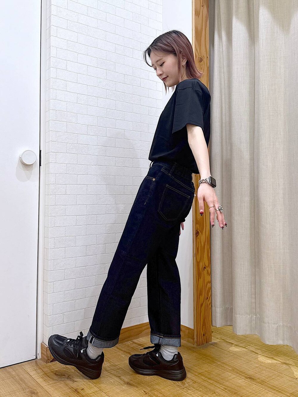 ブラック系のTシャツ/カットソー、ブルー系のデニムパンツ、グリーン系のボストンバッグを着用したレディースの春コーディネートの4枚目の写真