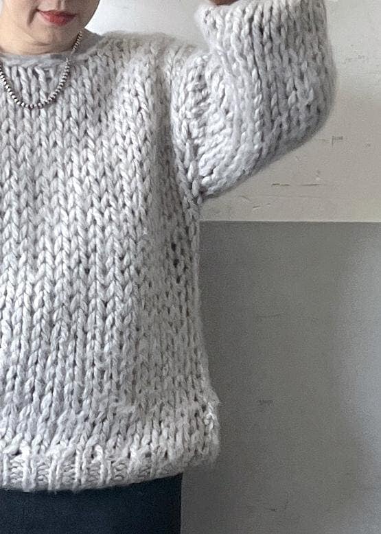 ブラック系のスカート、ホワイト系のショルダーバッグ、ホワイト系のスニーカーを着用したレディースの冬コーディネートの3枚目の写真