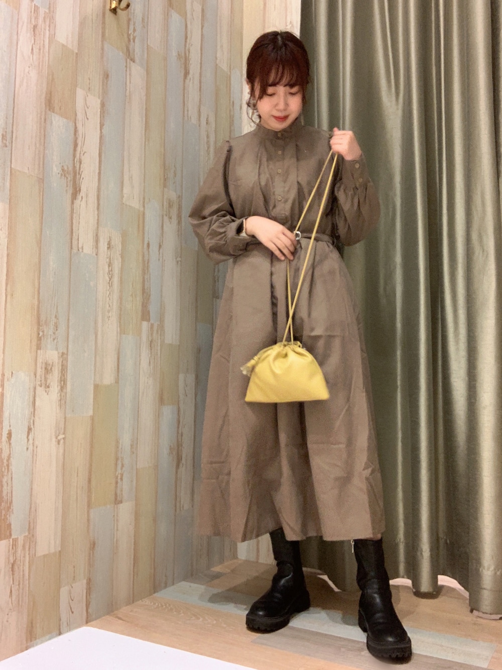 ベージュ系のワンピース、ホワイト系のベストを着用したレディースの春コーディネートの2枚目の写真