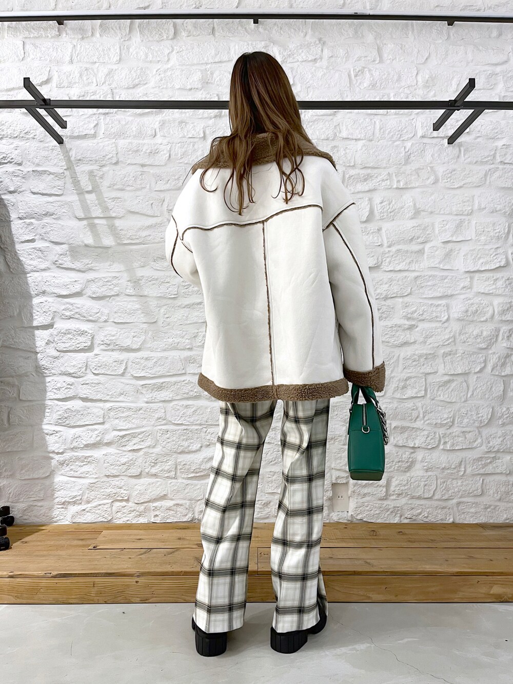 ベージュ系のブルゾン、グレー系のスウェット、ホワイト系のその他パンツを着用したレディースの冬コーディネートの3枚目の写真