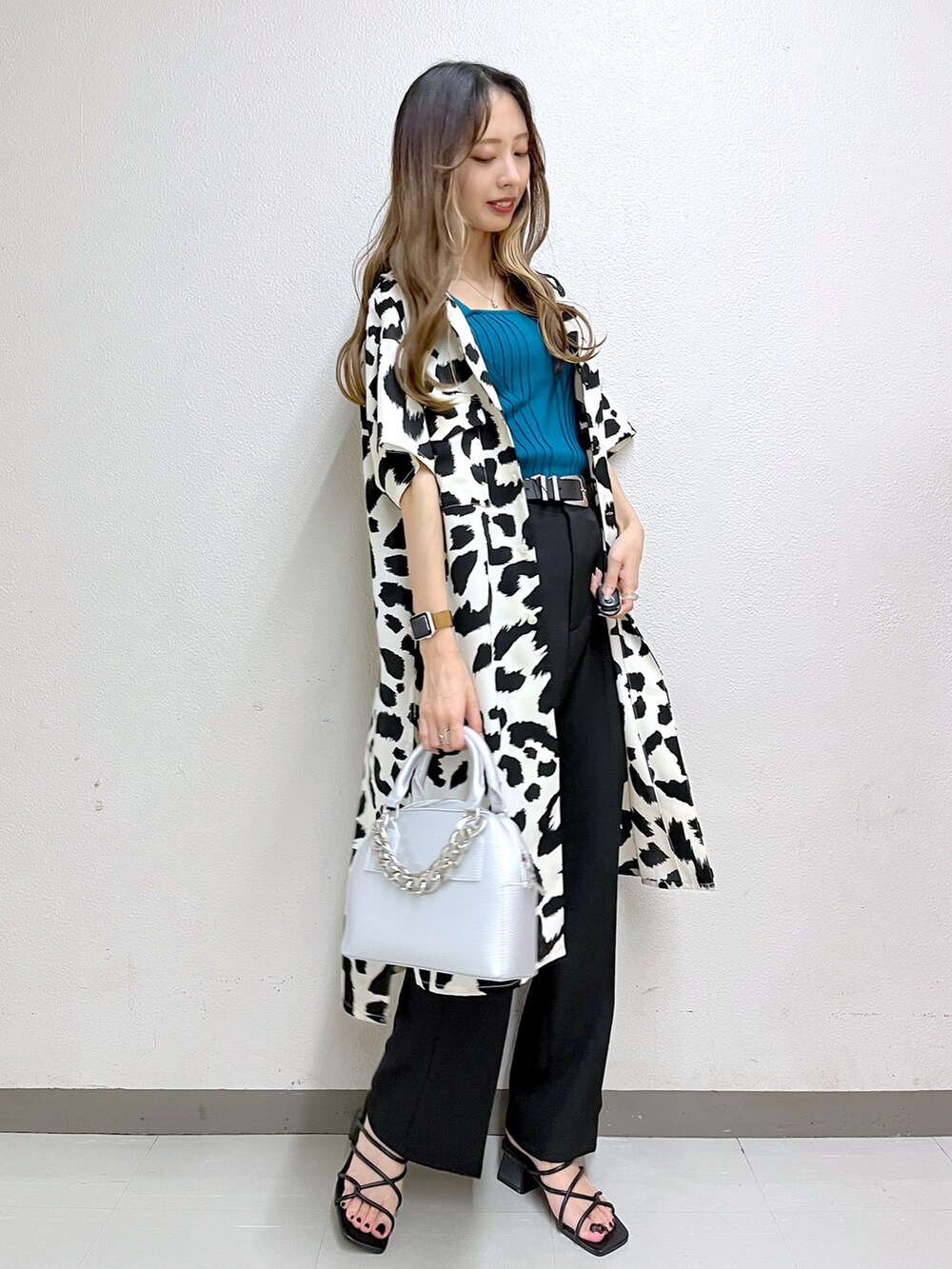 ホワイト系のシャツ/ブラウス、グリーン系のタンクトップ、ブラック系のスラックスを着用したレディースの夏コーディネートの2枚目の写真