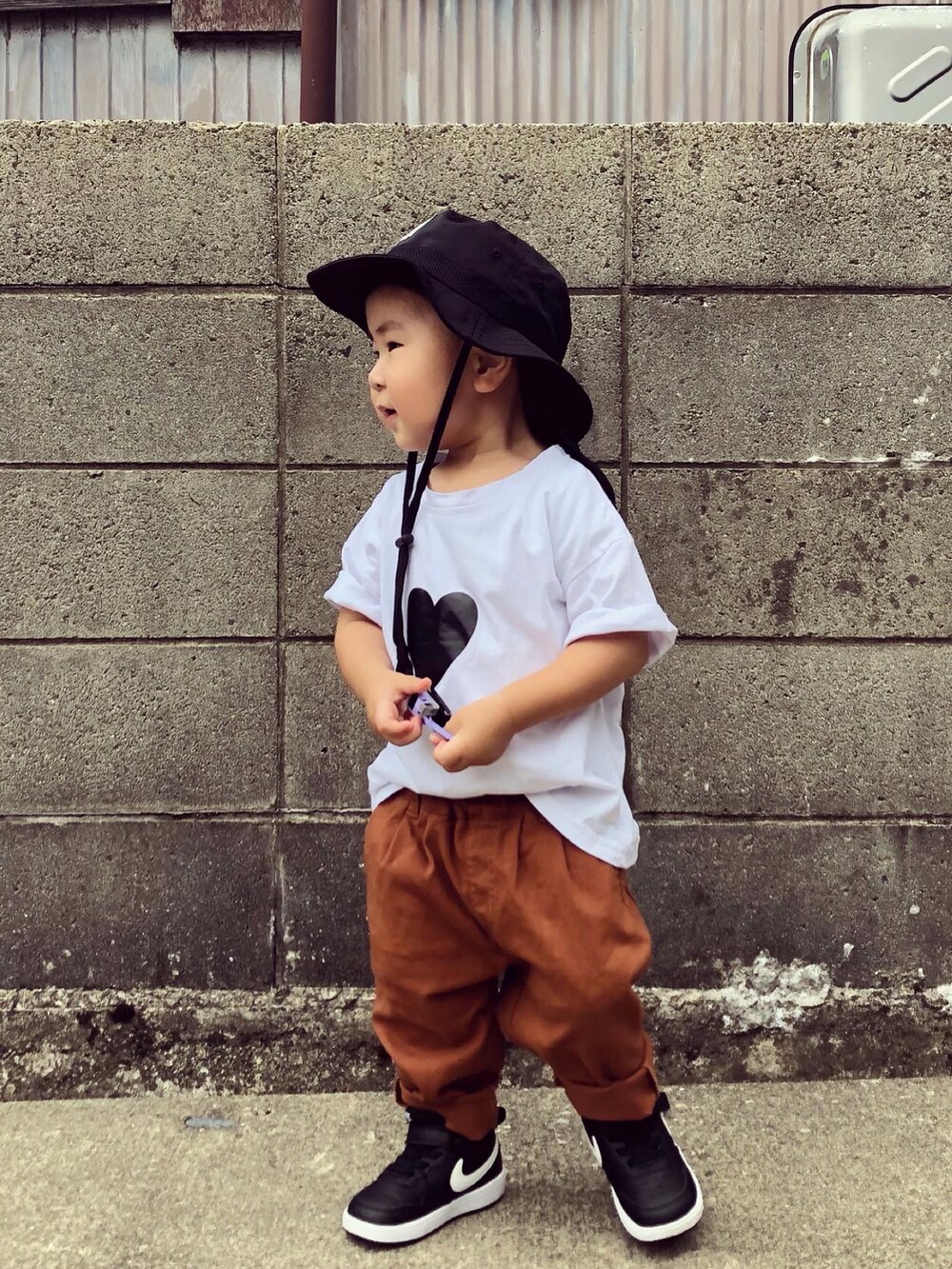 ホワイト系のTシャツ/カットソー、イエロー系のその他パンツ、ブラック系のスニーカーを着用したキッズの夏コーディネートの2枚目の写真