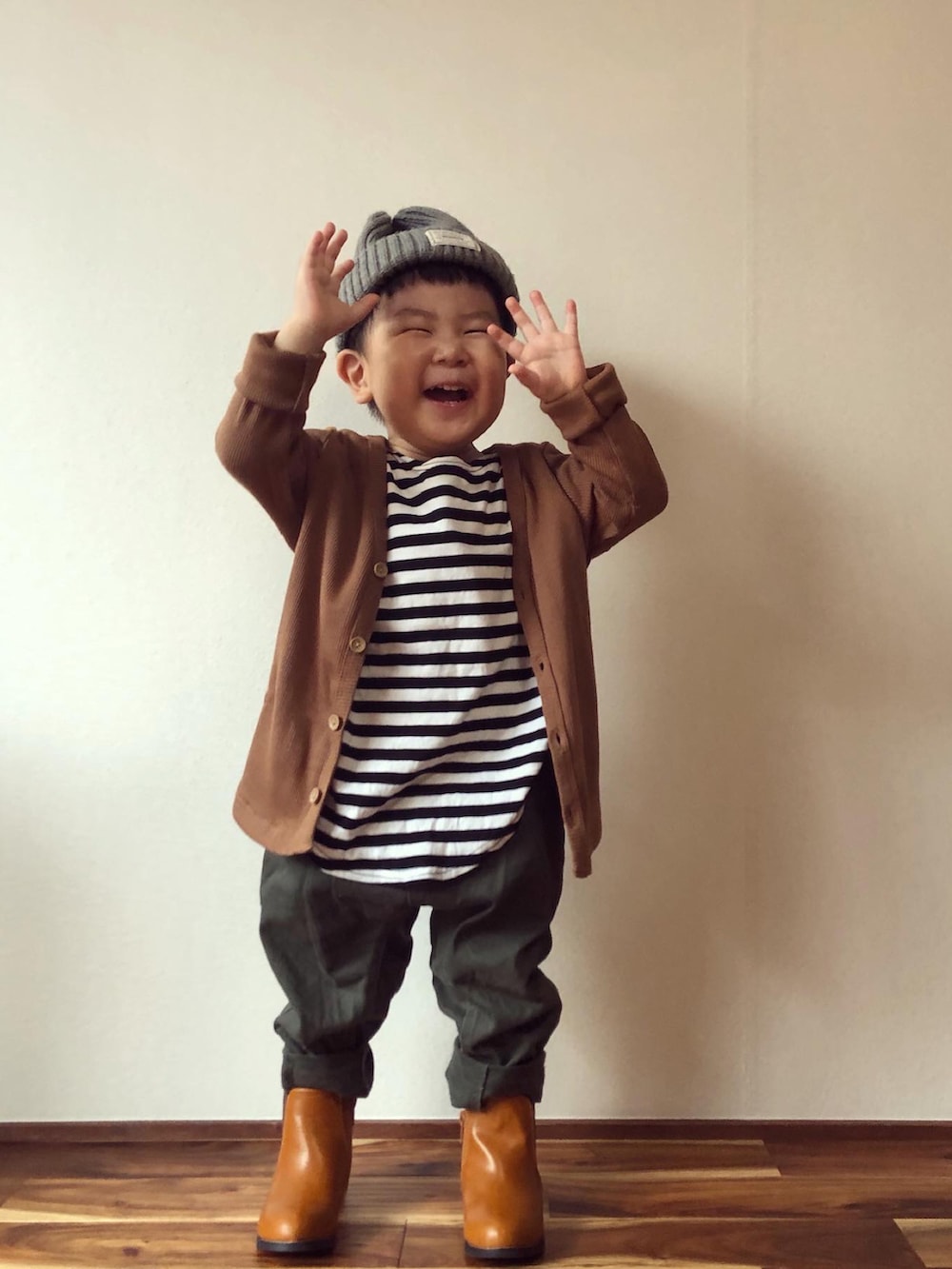 ブラウン系のカーディガン/ボレロ、ブラック系のTシャツ/カットソー、グリーン系のその他パンツを着用したキッズの秋コーディネートの3枚目の写真