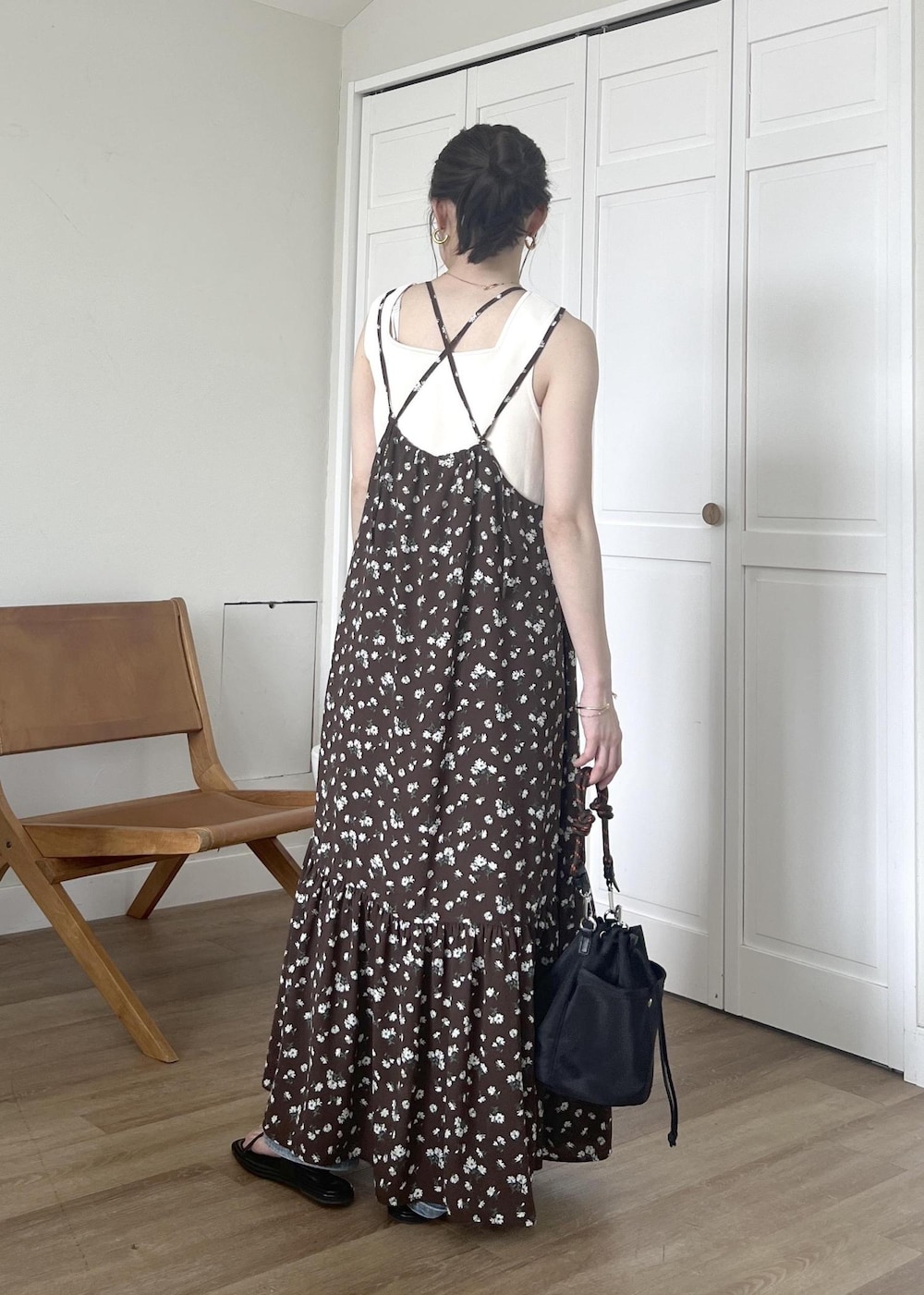 ブルー系のデニムパンツ、ブラック系のショルダーバッグ、ホワイト系のタンクトップを着用したレディースの春コーディネートの6枚目の写真