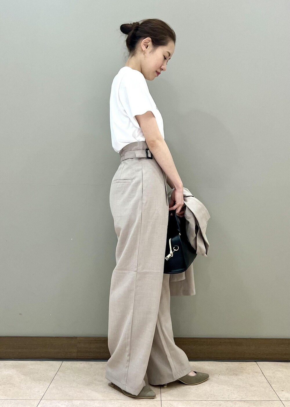 ブラック系のボストンバッグ、ベージュ系のテーラードジャケット、ホワイト系のTシャツ/カットソーを着用したレディースの夏コーディネートの2枚目の写真