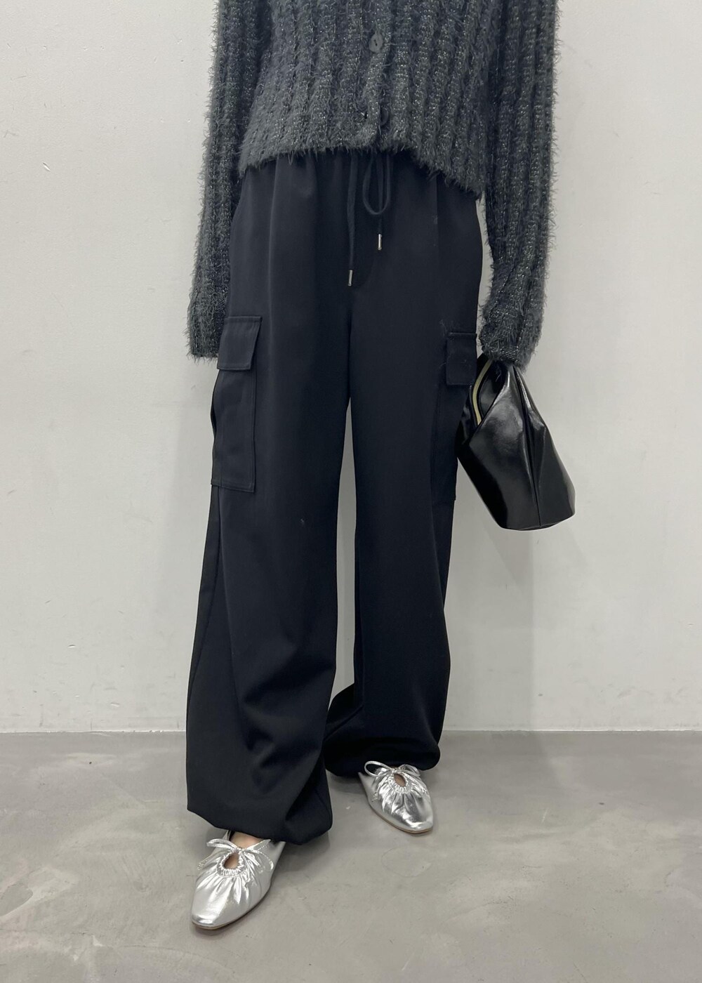 ブラック系のカーゴパンツ、グレー系のカーディガン/ボレロ、ブラック系のショルダーバッグを着用したレディースの冬コーディネートの5枚目の写真