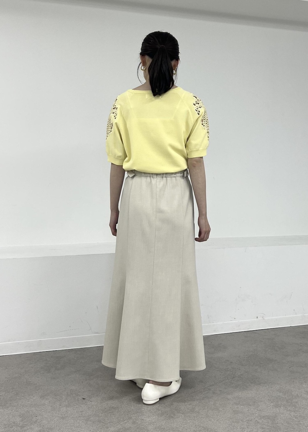 ホワイト系のパンプス、ベージュ系のテーラードジャケット、ベージュ系のスカートを着用したレディースの春コーディネートの7枚目の写真