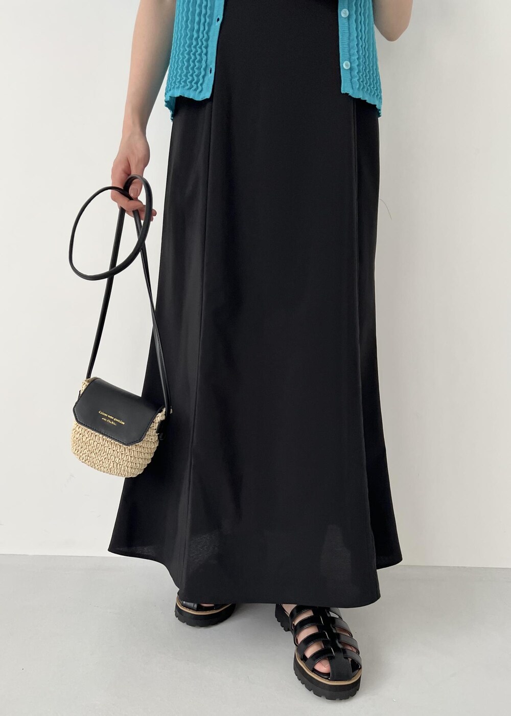 ブラック系のワンピース、ホワイト系のタンクトップ、ブラック系のサンダルを着用したレディースの夏コーディネートの6枚目の写真