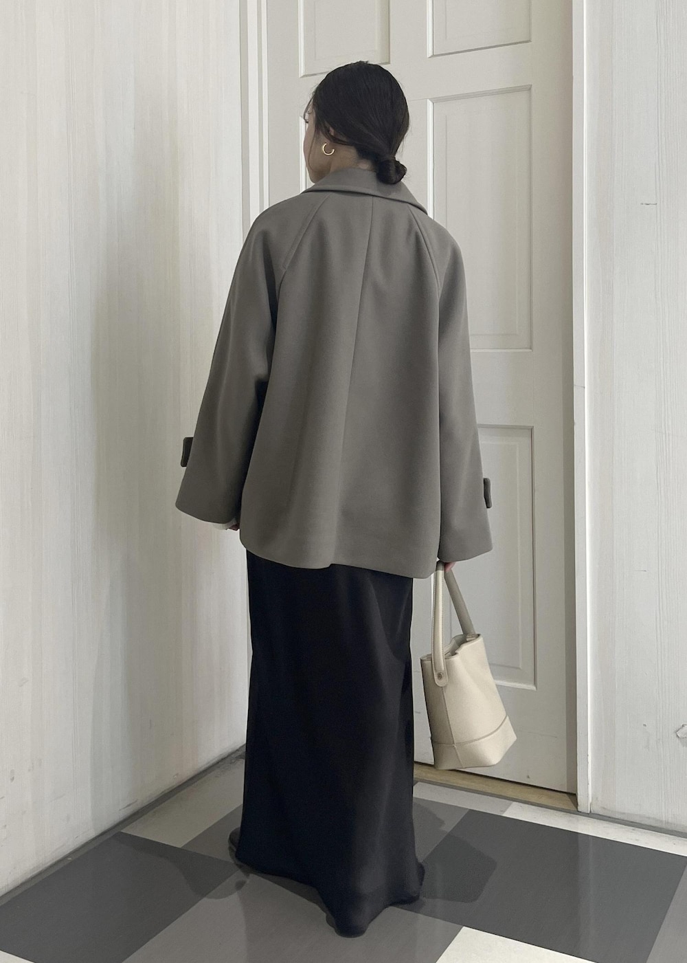 ホワイト系のニット/セーター、ブラウン系のその他アウター、ベージュ系のショルダーバッグを着用したレディースの冬コーディネートの7枚目の写真