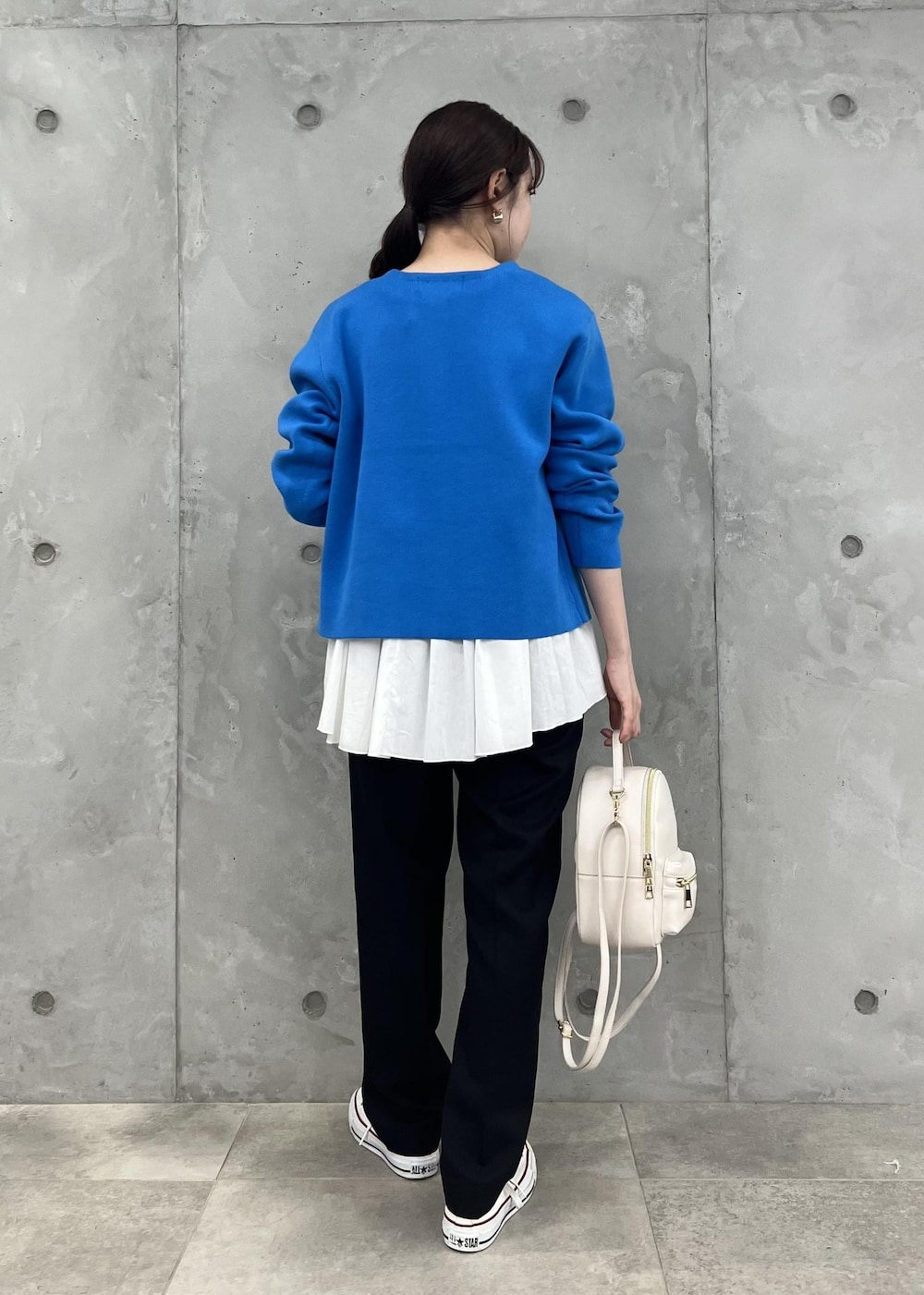 ブラック系のその他パンツ、ホワイト系のバックパック/リュック、ブルー系のカーディガン/ボレロを着用したレディースの秋コーディネートの3枚目の写真