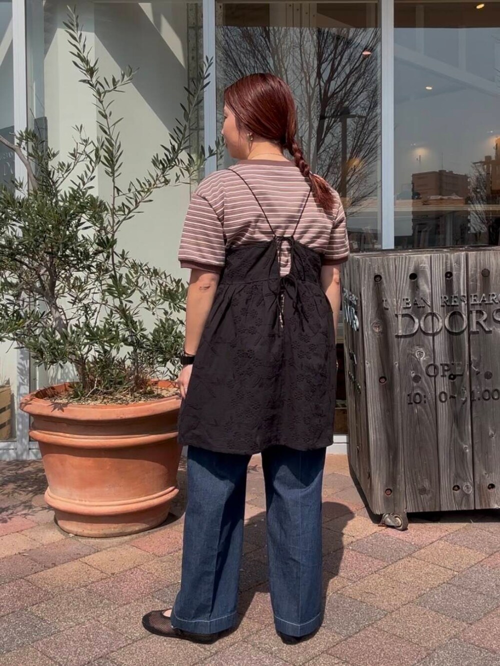ブルー系のデニムパンツ、ブラック系のキャミソールを着用したレディースの春コーディネートの3枚目の写真