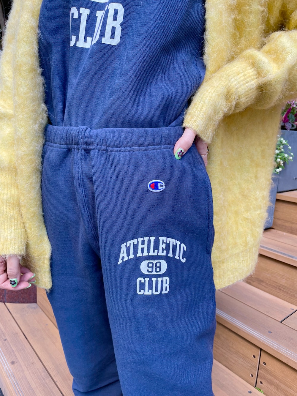 イエロー系のカーディガン/ボレロ、ブルー系のスウェットパンツ、ブルー系のスウェットを着用したレディースの秋コーディネートの4枚目の写真