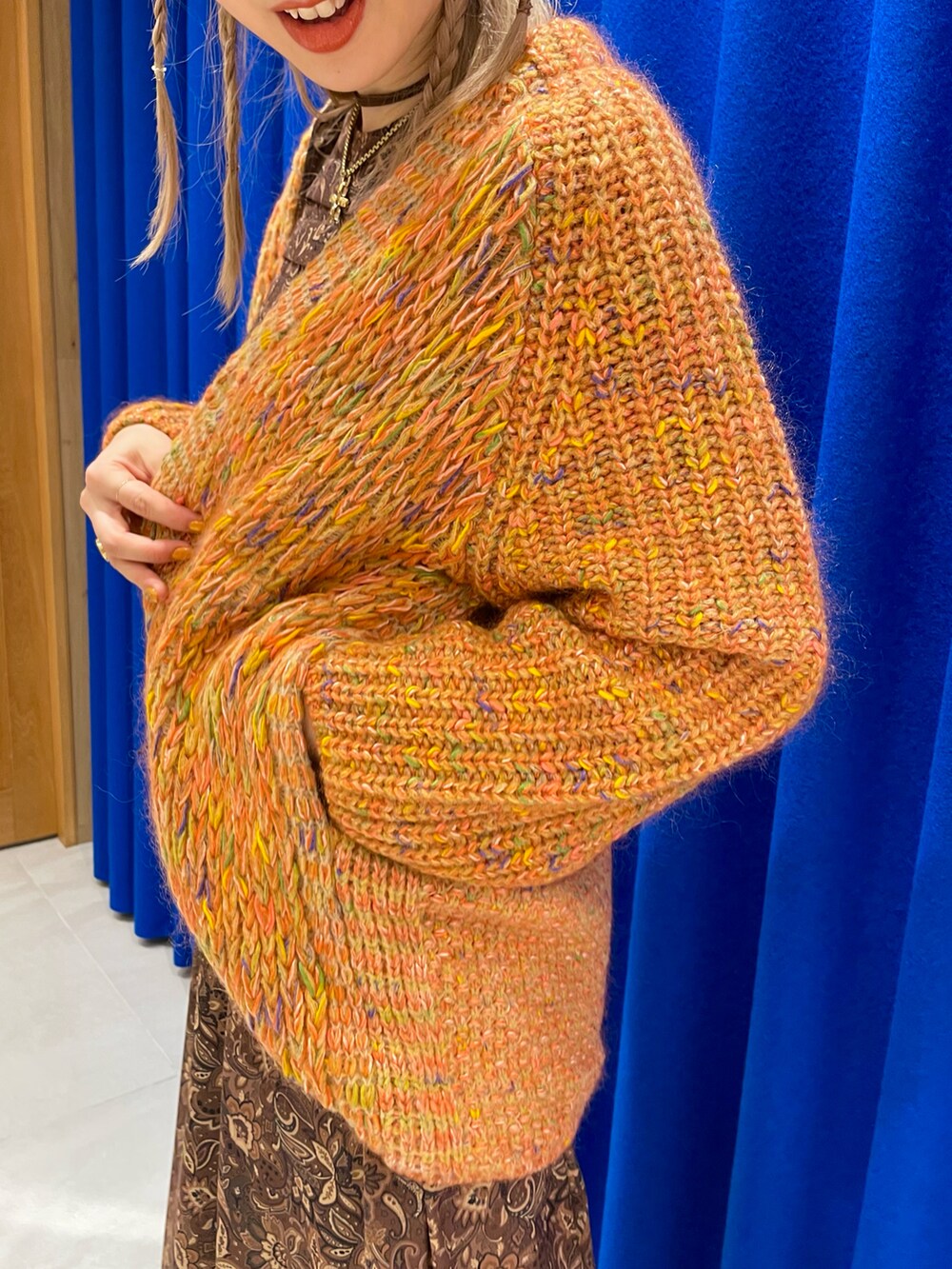 ブラウン系のワンピース、オレンジ系のカーディガン/ボレロを着用したレディースの秋コーディネートの5枚目の写真