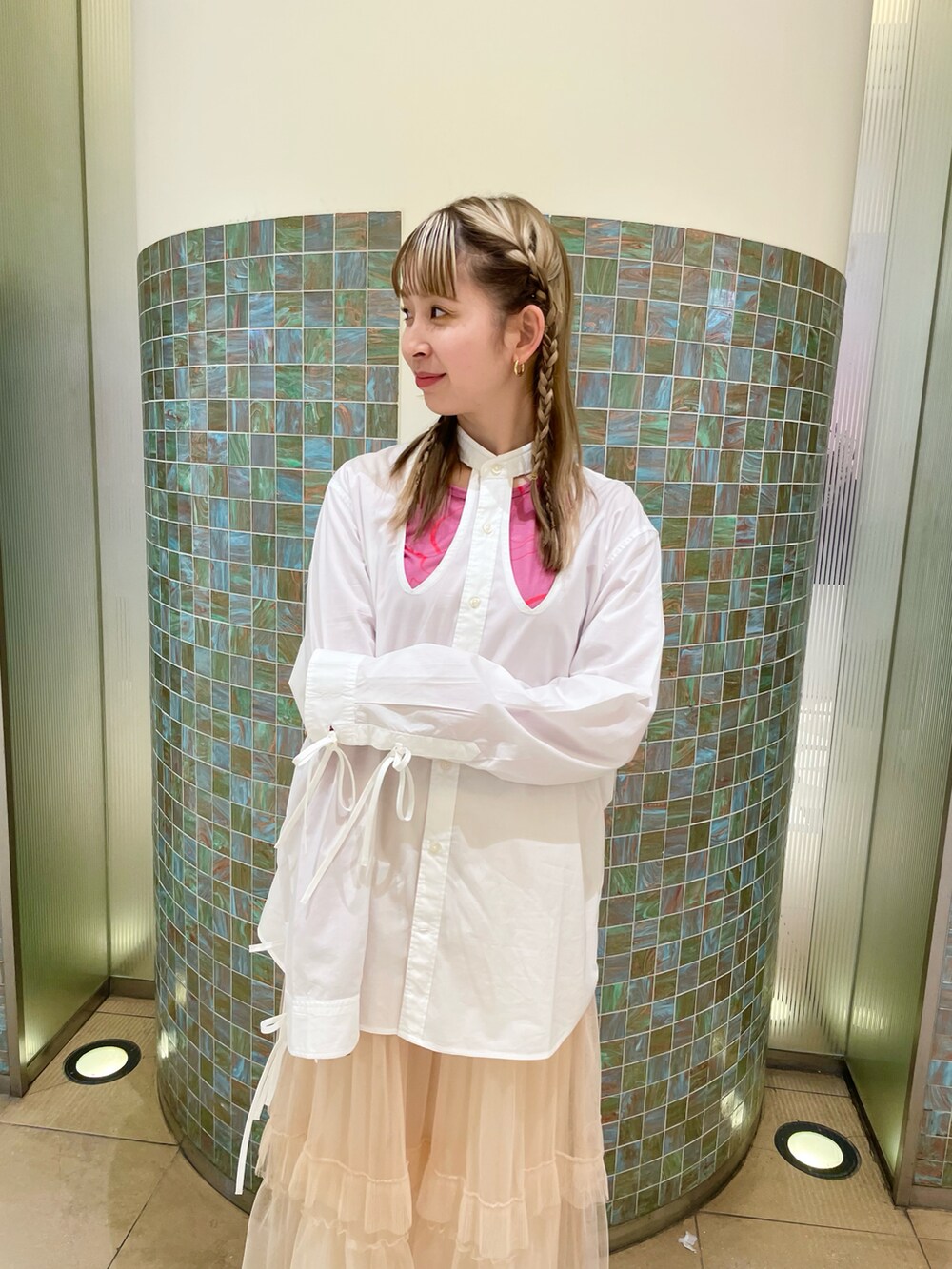 ベージュ系のスカート、ピンク系のトップスを着用したレディースの冬コーディネートの3枚目の写真