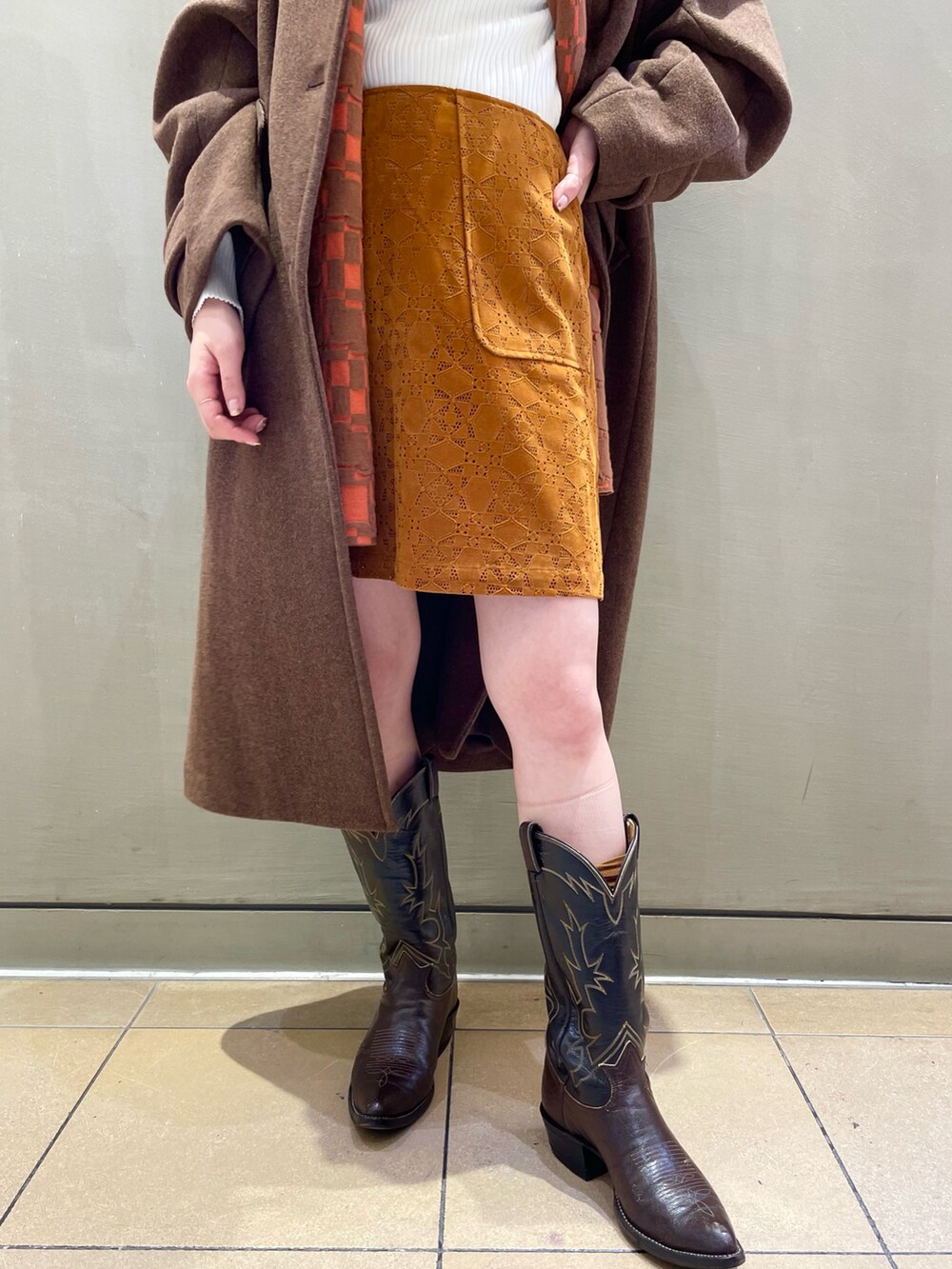 ブラウン系のその他アウター、ホワイト系のニット/セーター、ブラウン系のスカートを着用したレディースの秋コーディネートの4枚目の写真