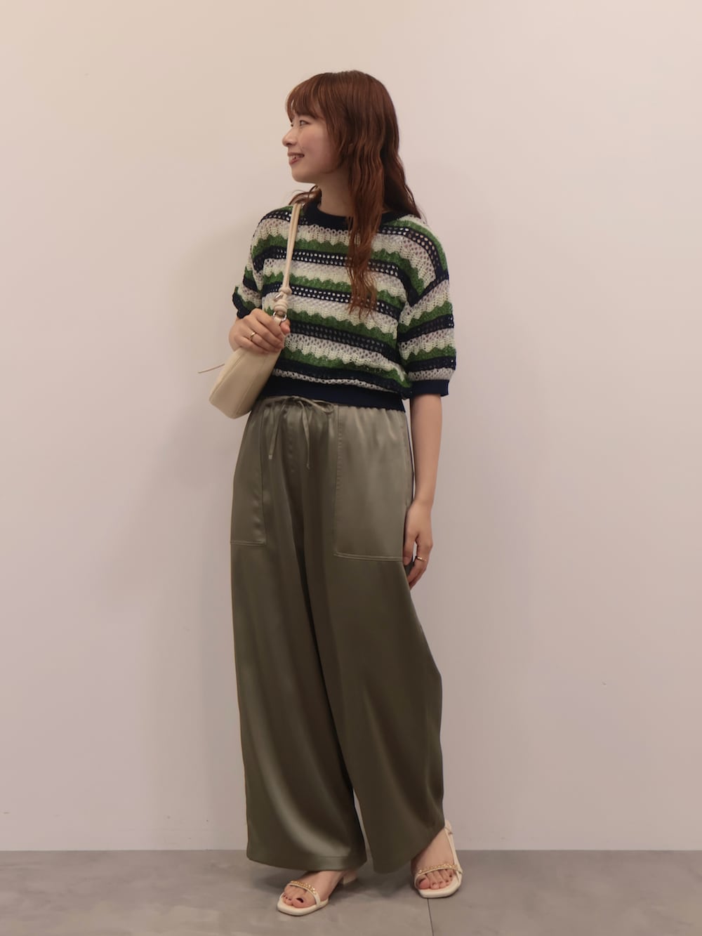 グリーン系のその他パンツ、ホワイト系のショルダーバッグ、ホワイト系のサンダルを着用したレディースの夏コーディネートの2枚目の写真