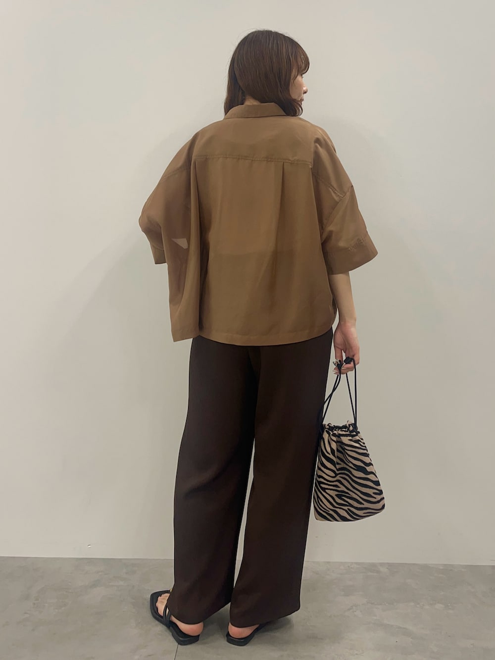 ベージュ系のシャツ/ブラウス、ブラウン系のその他パンツ、その他のショルダーバッグを着用したレディースの春コーディネートの3枚目の写真