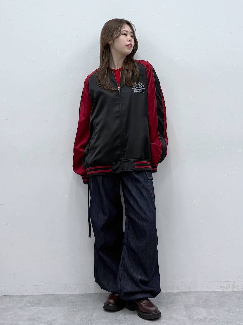 ブラック系のスカジャンを着用したレディースの春コーディネートの2枚目の写真