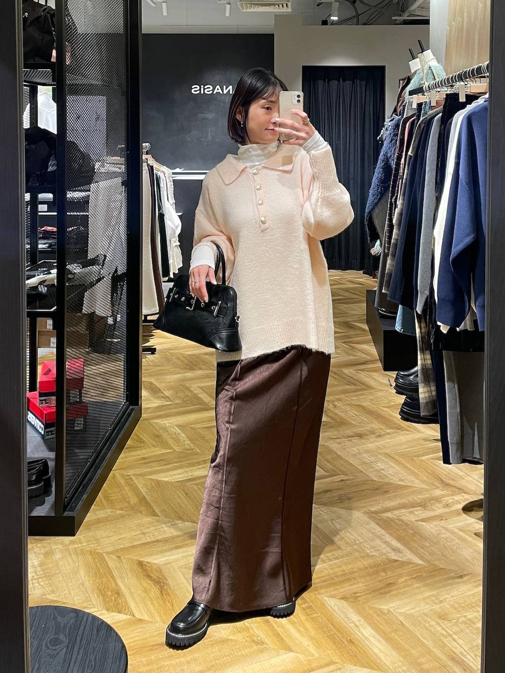 ブラック系のローファー、ブラック系のボストンバッグ、ホワイト系のTシャツ/カットソーを着用したレディースの冬コーディネートの5枚目の写真