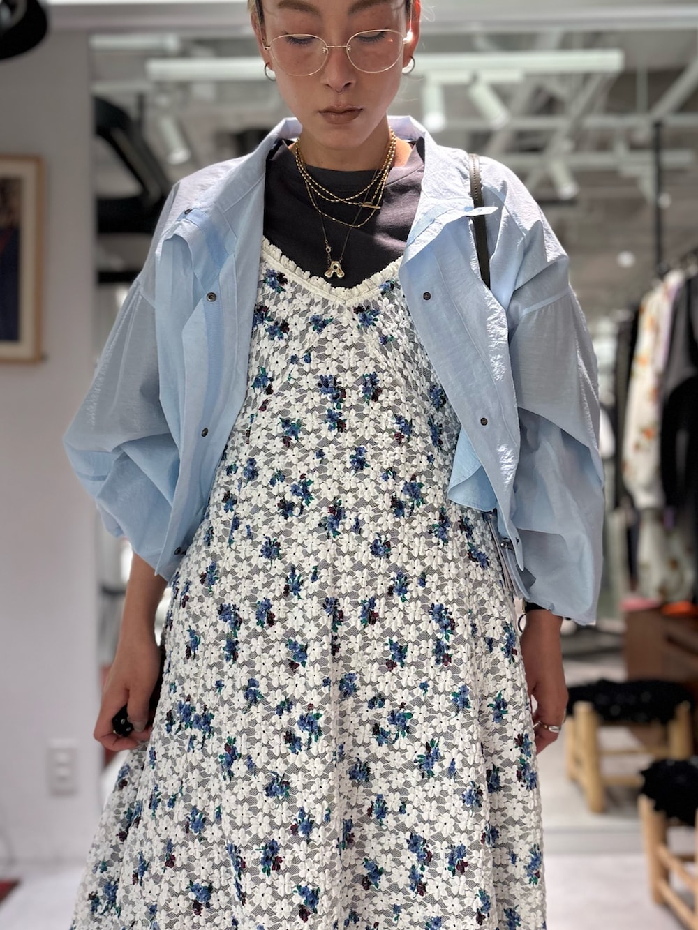 ホワイト系のワンピース、ブルー系のブルゾン、ブラック系のデニムパンツを着用したレディースの春コーディネートの5枚目の写真