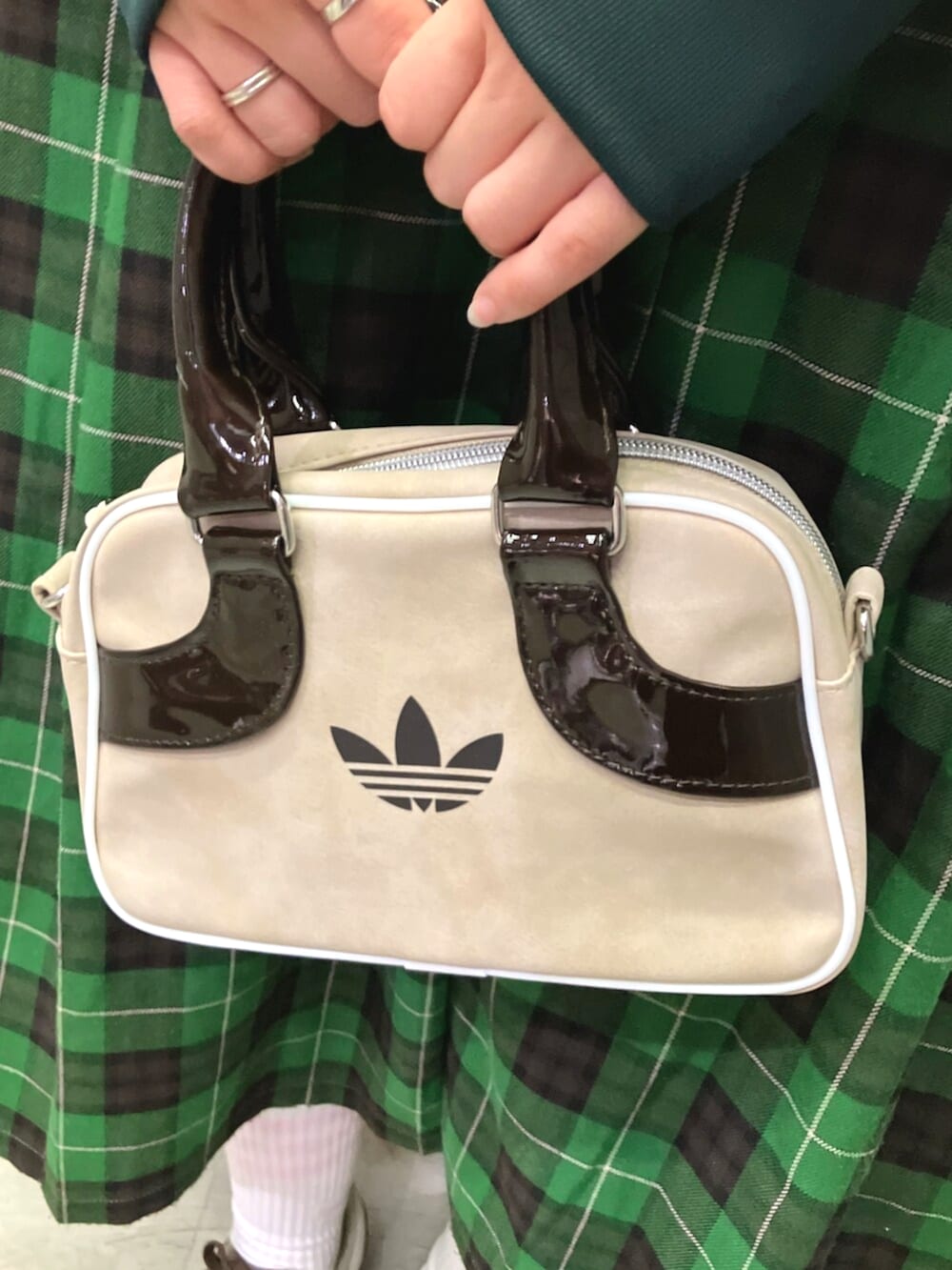 グリーン系のジャージ、ベージュ系のショルダーバッグ、ブラウン系のスニーカーを着用したレディースの秋コーディネートの4枚目の写真