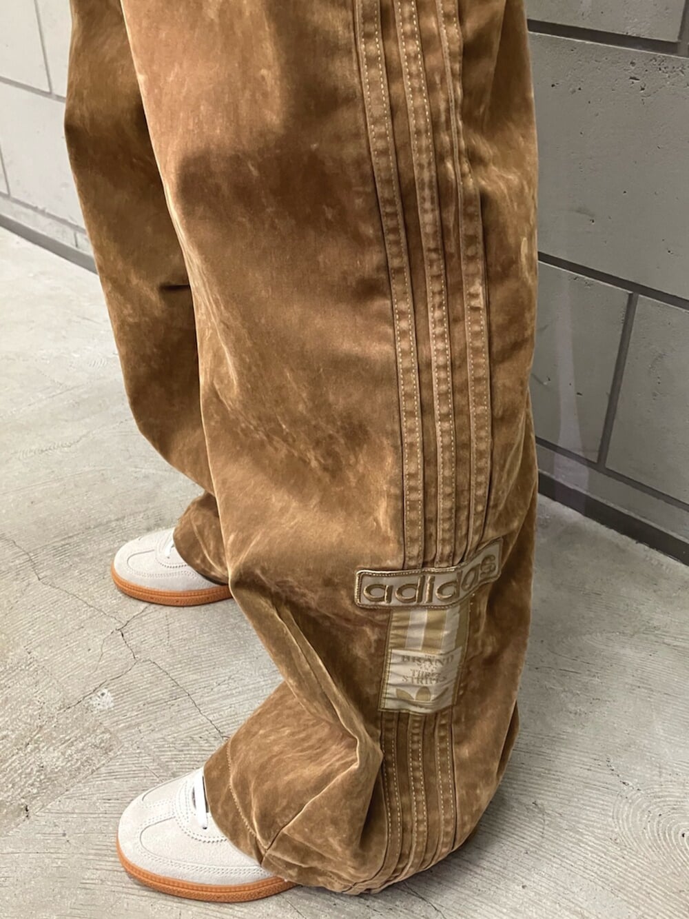 ブラウン系のその他パンツ、ベージュ系のショルダーバッグ、ベージュ系のスニーカーを着用したレディースの秋コーディネートの2枚目の写真