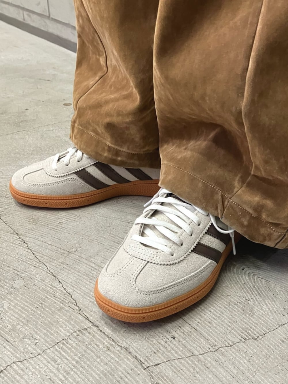 ブラウン系のその他パンツ、ベージュ系のショルダーバッグ、ベージュ系のスニーカーを着用したレディースの秋コーディネートの3枚目の写真