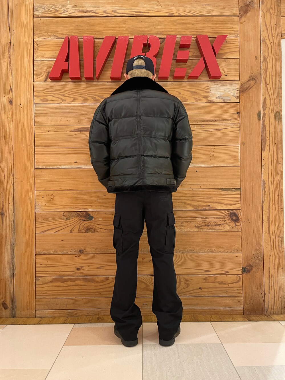 ブラック系のカーゴパンツ、ブラック系のダウンジャケット/コート、ブラック系のキャップを着用したメンズの冬コーディネートの2枚目の写真