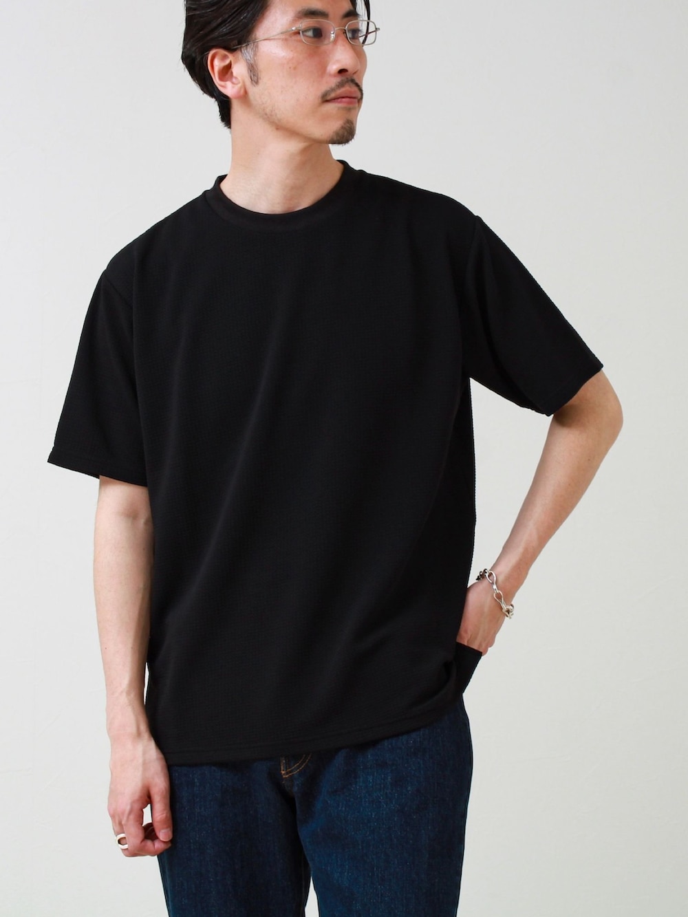 ブラック系のTシャツ/カットソー、ブルー系のデニムパンツを着用したメンズの春コーディネートの2枚目の写真