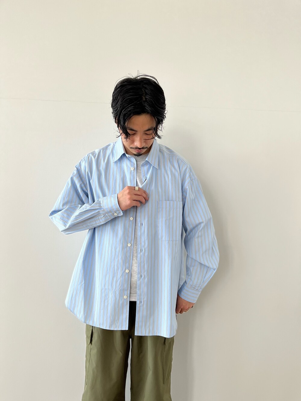 グリーン系のカーゴパンツ、ブルー系のシャツ/ブラウスを着用したメンズの春コーディネートの3枚目の写真