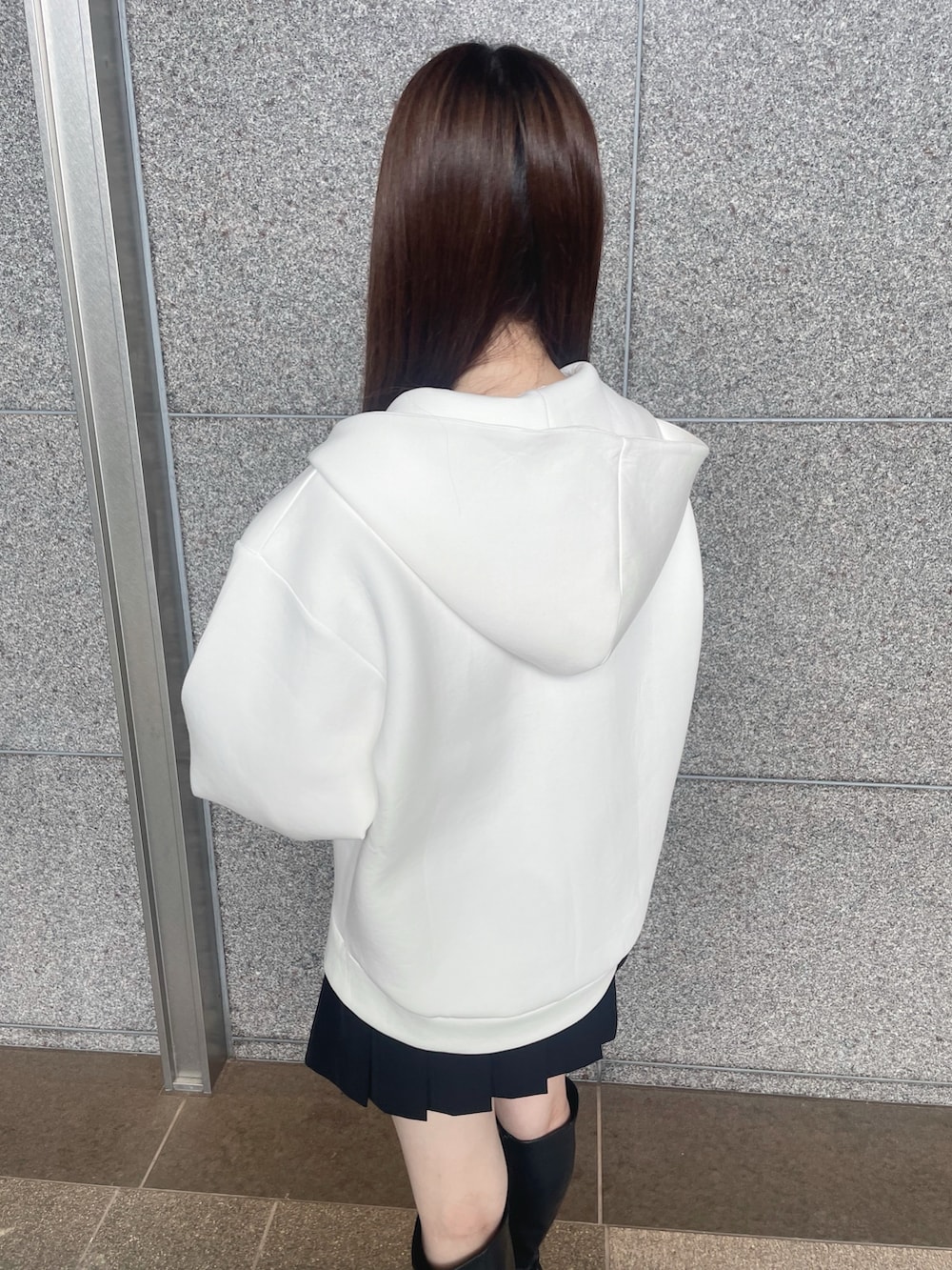 ホワイト系のパーカー、ブラック系のその他パンツ、ブラック系のブーツを着用したレディースの秋コーディネートの8枚目の写真