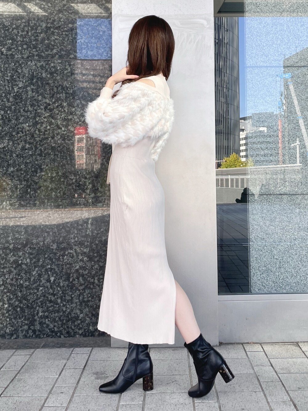 ベージュ系のワンピース、ホワイト系のショルダーバッグ、ブラック系のブーツを着用したレディースの冬コーディネートの5枚目の写真