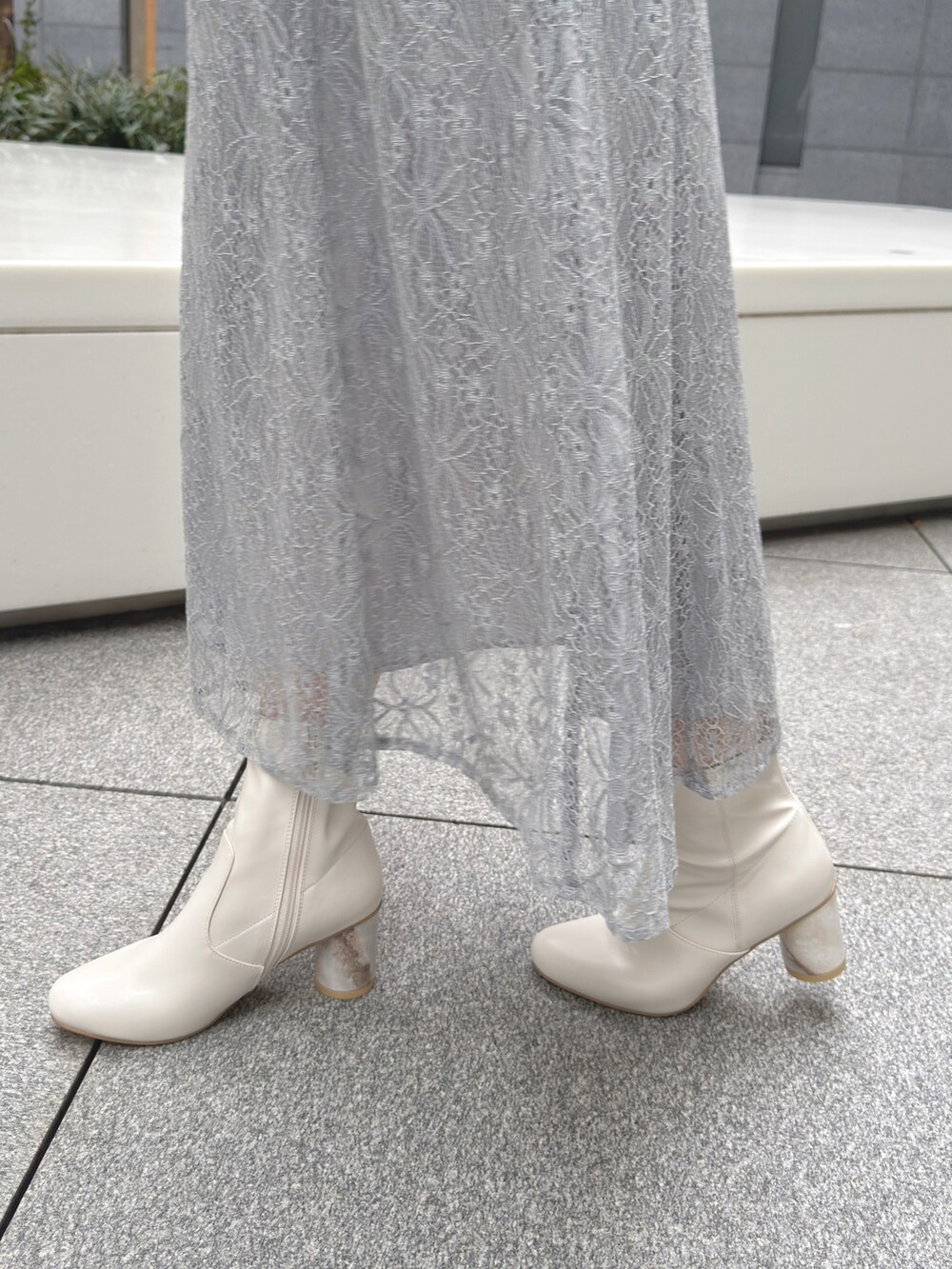 ホワイト系のハンドバッグ、ホワイト系のブーツ、ホワイト系のニット/セーターを着用したレディースの冬コーディネートの9枚目の写真