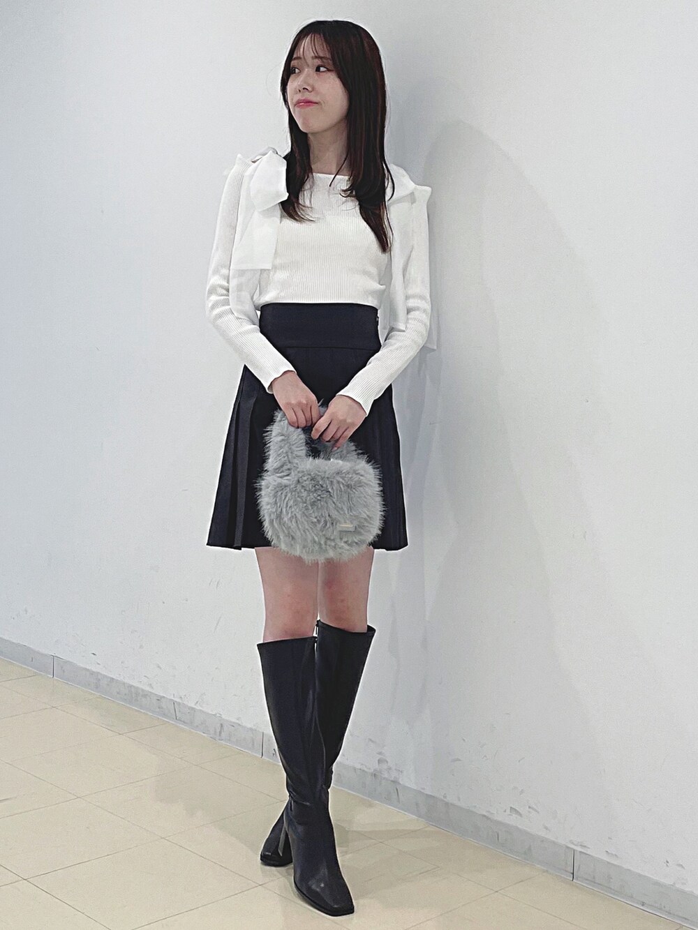 ホワイト系のニット/セーター、ブラウン系のその他パンツ、グレー系のハンドバッグを着用したレディースの秋コーディネートの3枚目の写真