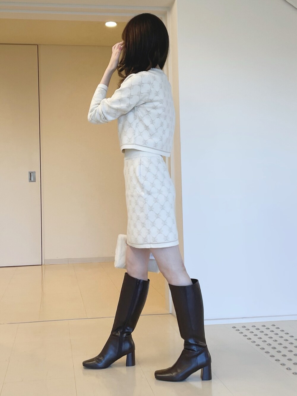 ホワイト系のワンピースを着用したレディースの冬コーディネートの3枚目の写真