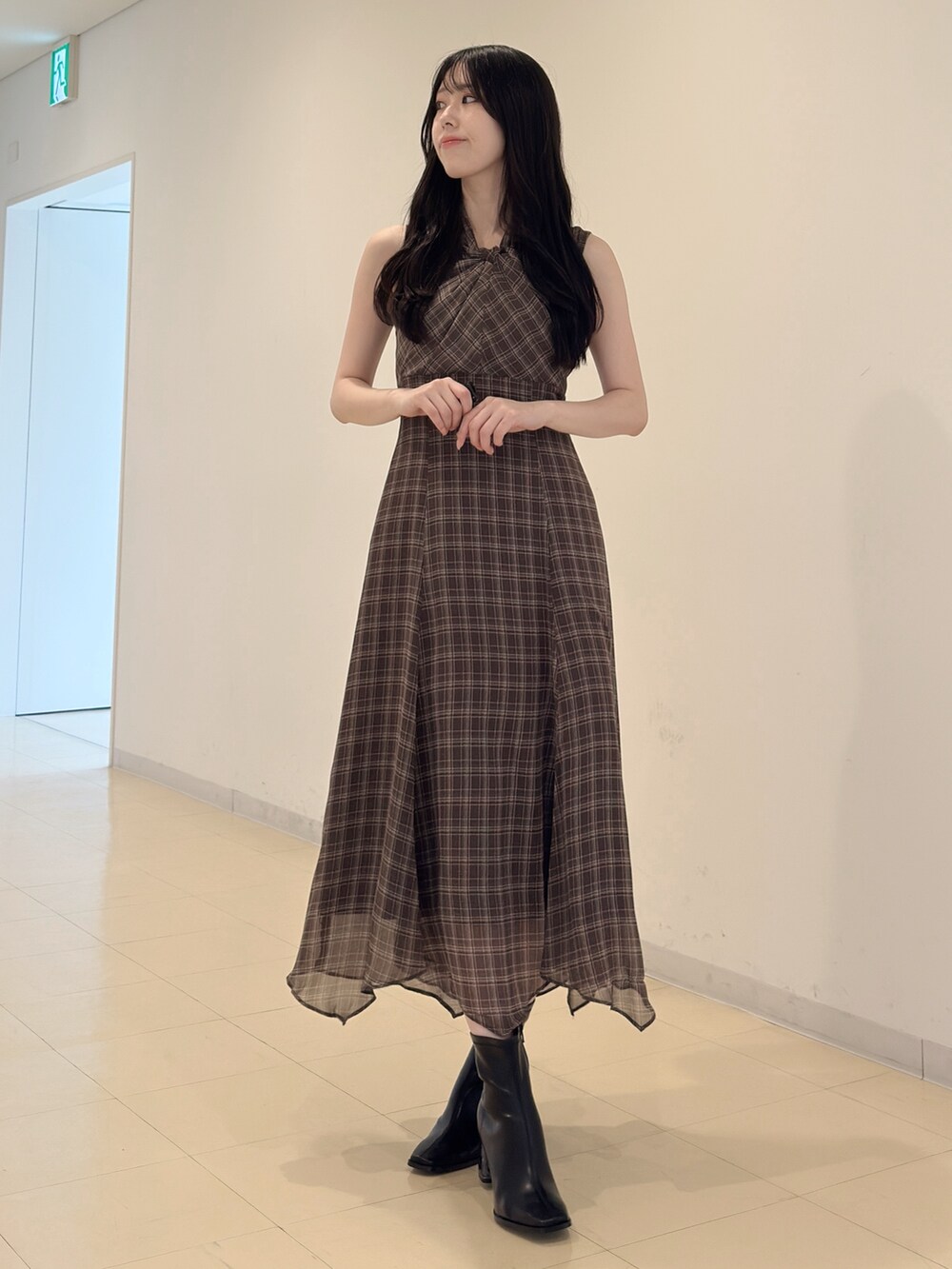 ホワイト系のカーディガン/ボレロ、ブラウン系のワンピース、ブラック系のブーツを着用したレディースの夏コーディネートの4枚目の写真