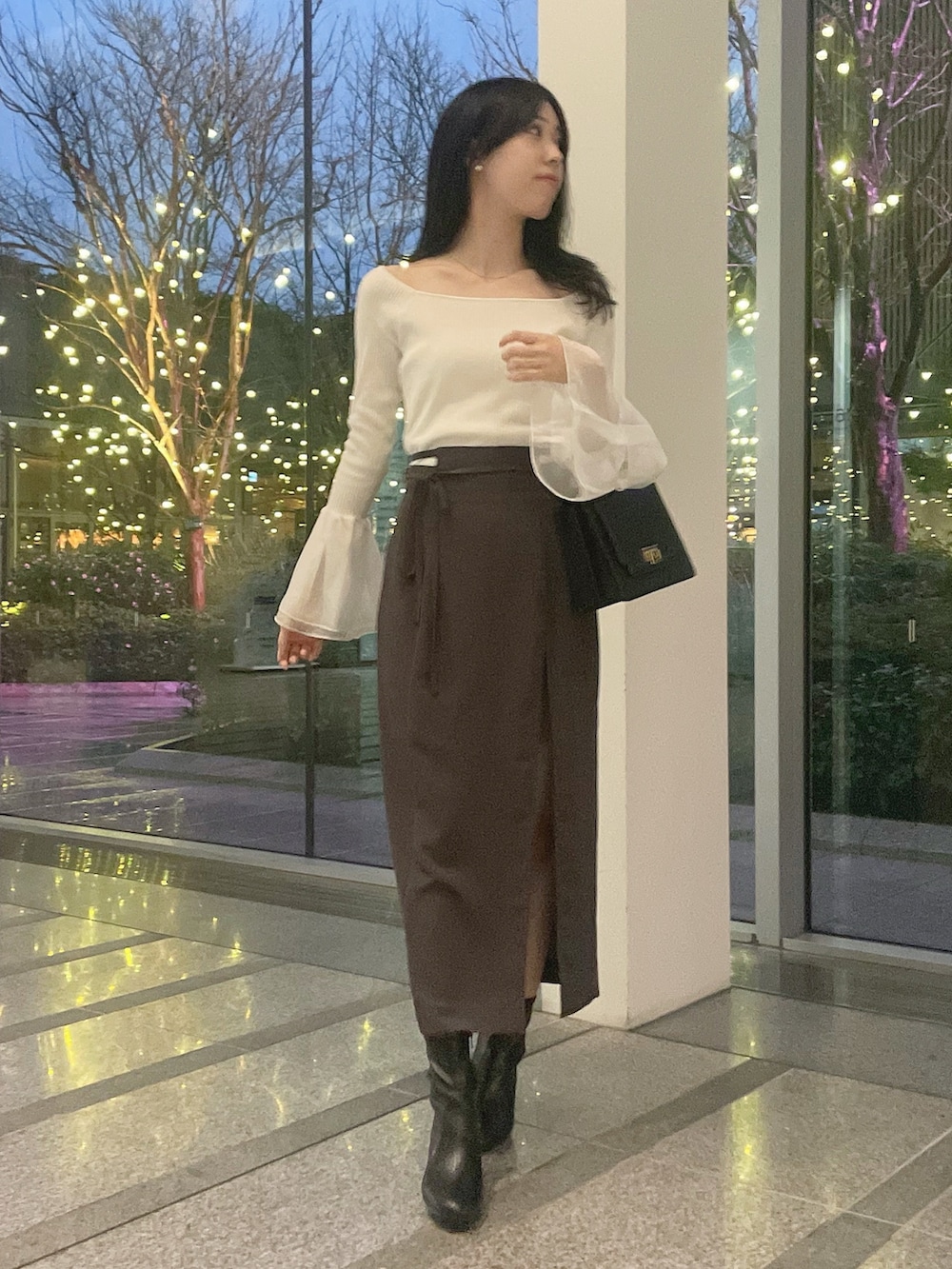 ホワイト系のテーラードジャケット、ホワイト系のニット/セーター、グレー系のスカートを着用したレディースの冬コーディネートの6枚目の写真