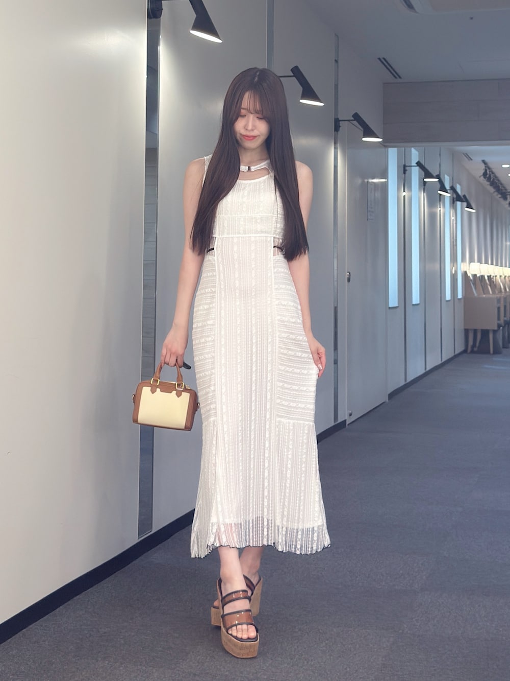 その他のワンピース、ブラウン系のハンドバッグ、ブラウン系のサンダルを着用したレディースの夏コーディネートの2枚目の写真
