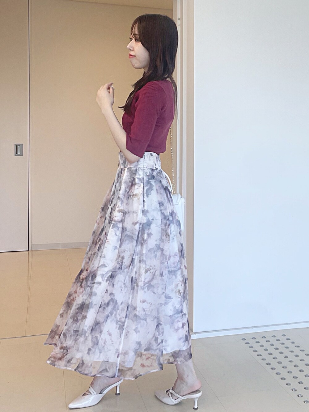 ピンク系のニット/セーター、ホワイト系のスカート、ホワイト系のショルダーバッグを着用したレディースの夏コーディネートの4枚目の写真