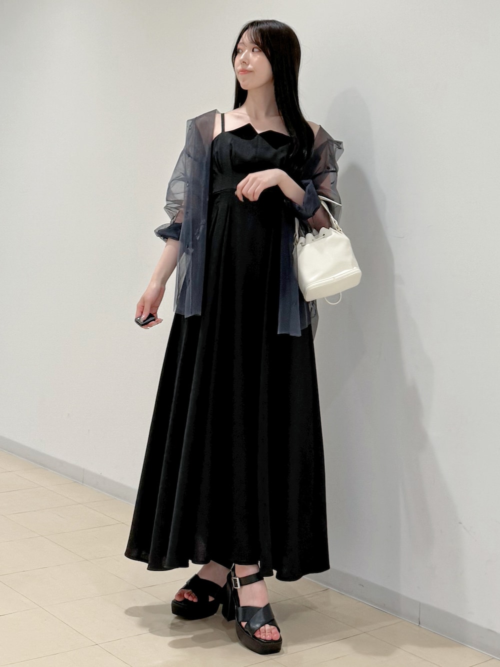 グレー系のシャツ/ブラウス、ブラック系のワンピース、ホワイト系のハンドバッグを着用したレディースの春コーディネートの3枚目の写真