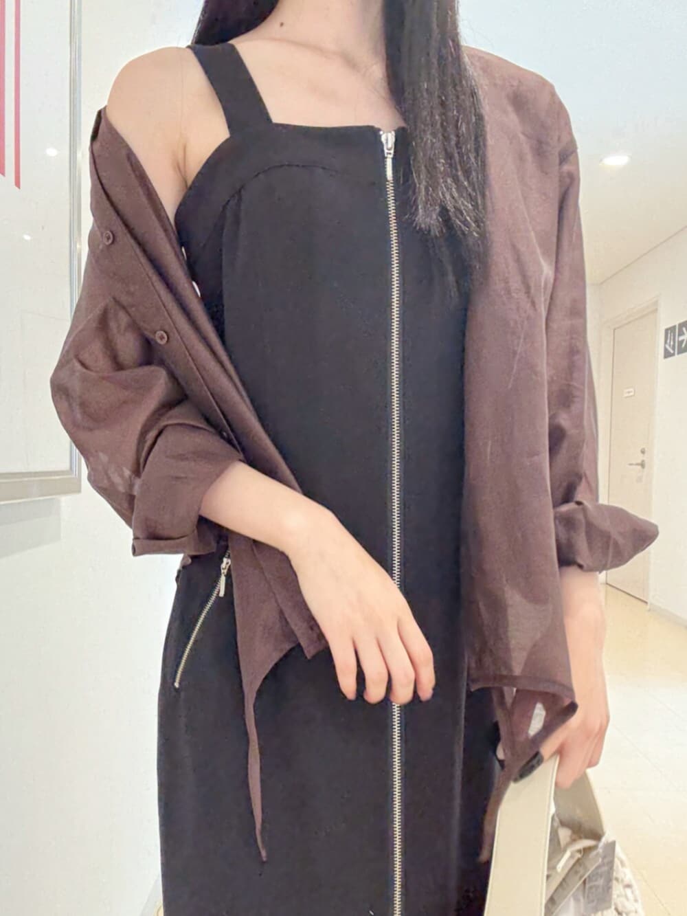 ブラック系のサンダル、ホワイト系のショルダーバッグ、ブラック系のワンピースを着用したレディースの夏コーディネートの5枚目の写真