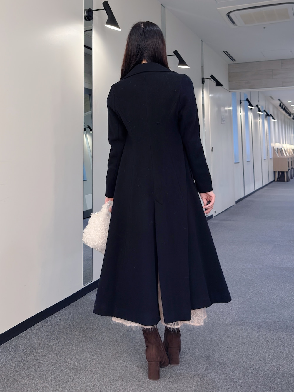 ブラック系のその他アウター、ホワイト系のニット/セーター、ピンク系のスカートを着用したレディースの秋コーディネートの5枚目の写真