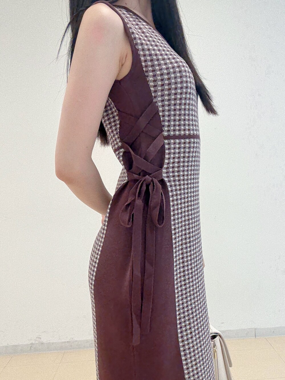 ブラウン系のワンピース、ホワイト系のハンドバッグ、グレー系のパンプスを着用したレディースの夏コーディネートの7枚目の写真