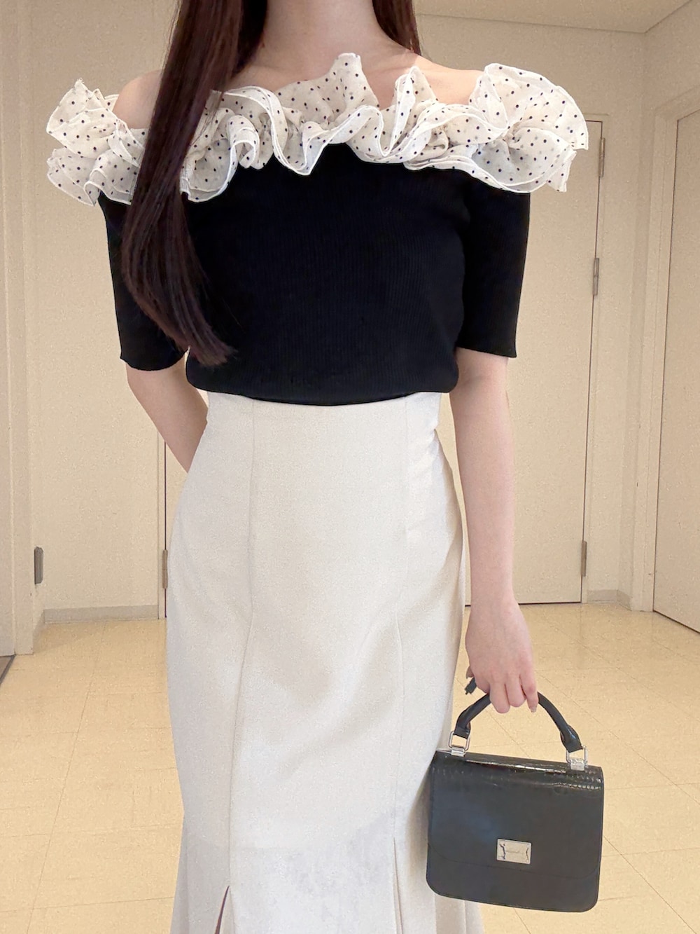 その他のニット/セーター、ホワイト系のスカート、ブラック系のハンドバッグを着用したレディースの春コーディネートの5枚目の写真