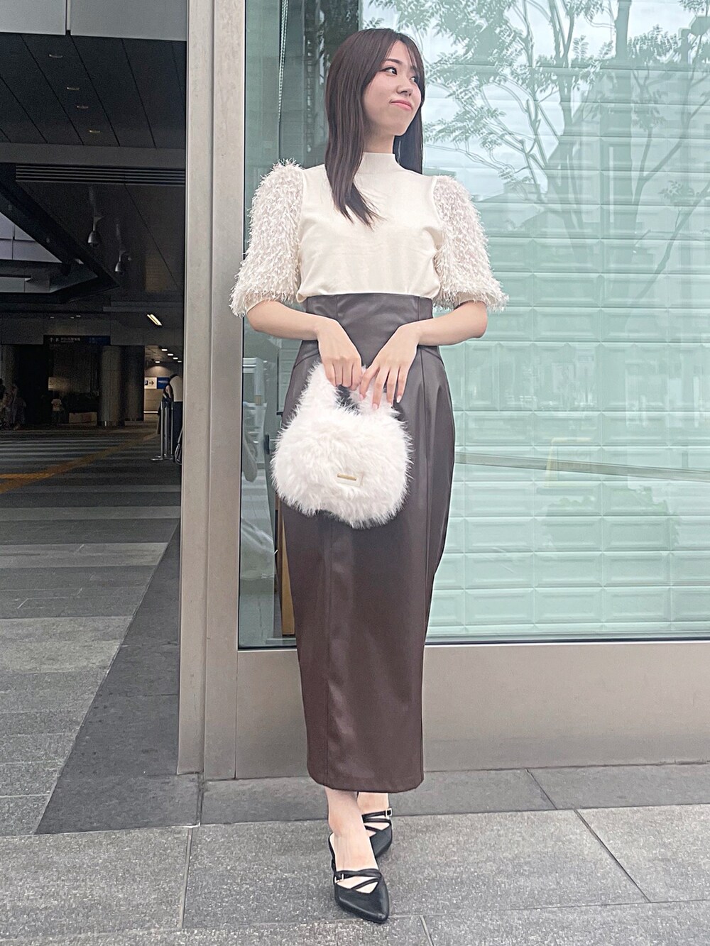 ホワイト系のニット/セーター、ブラウン系のスカート、ホワイト系のハンドバッグを着用したレディースの夏コーディネートの3枚目の写真
