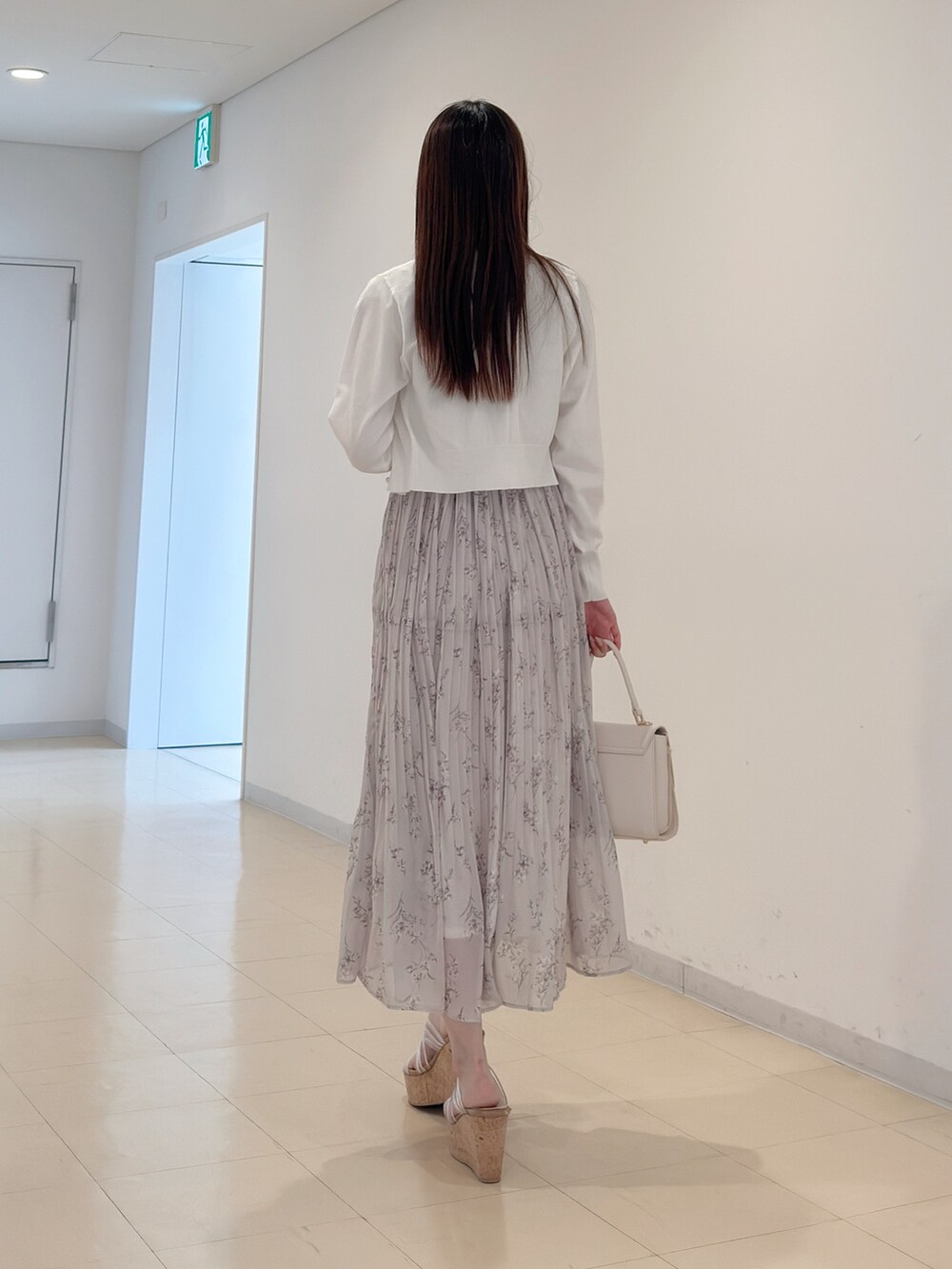 ホワイト系のカーディガン/ボレロ、ピンク系のワンピース、ホワイト系のハンドバッグを着用したレディースの春コーディネートの5枚目の写真