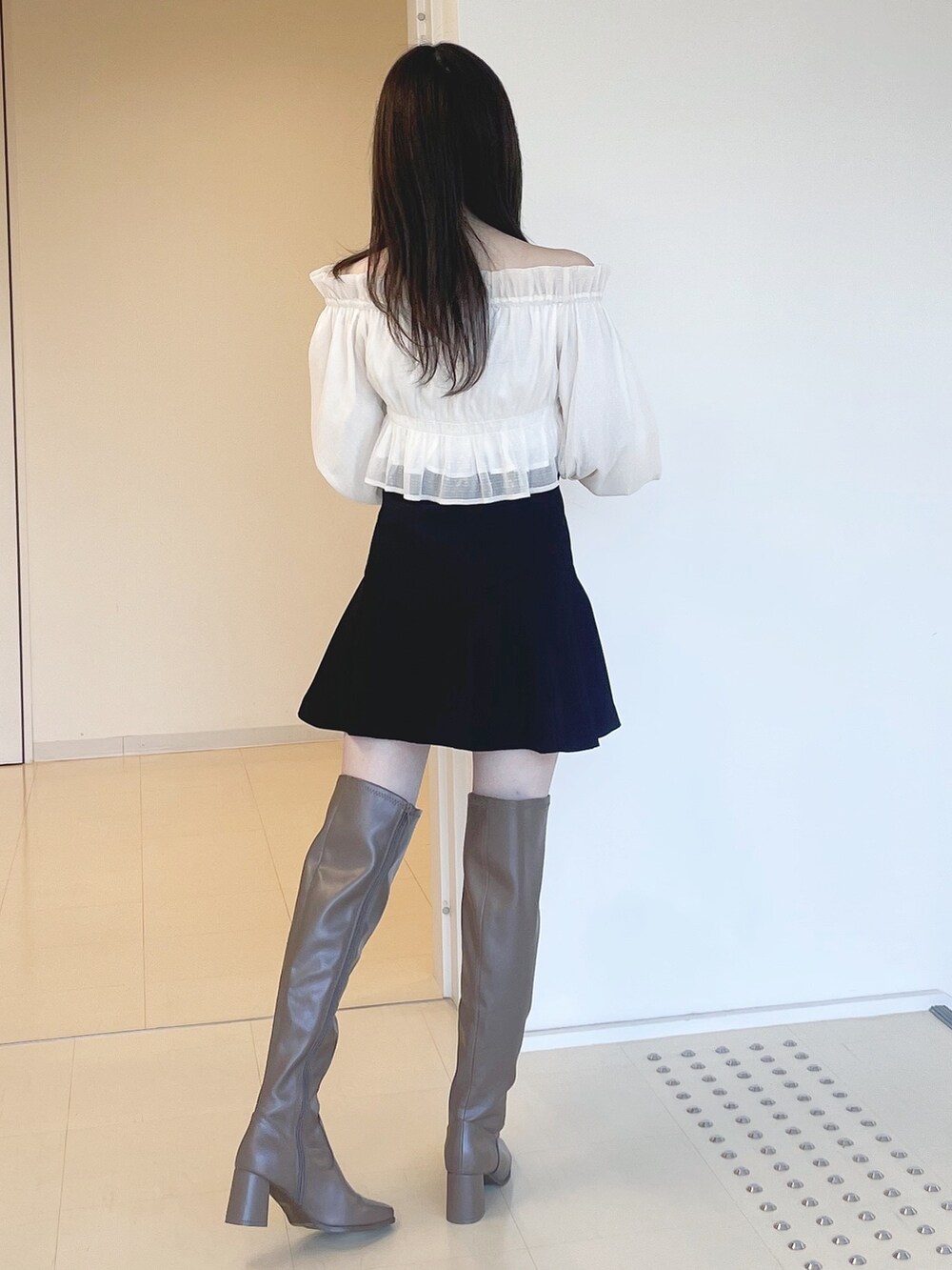 ホワイト系のシャツ/ブラウス、ブラック系のその他パンツ、ブラウン系のブーツを着用したレディースの冬コーディネートの5枚目の写真