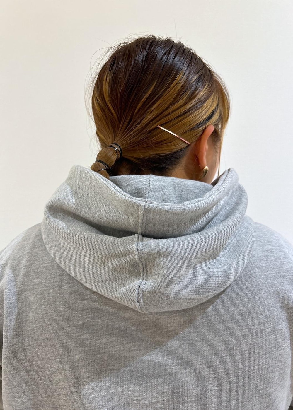 ブルー系のショルダーバッグ、ブラウン系のスカート、グレー系のパーカーを着用したレディースの秋コーディネートの8枚目の写真